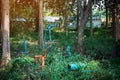 Old outdoor exercise equipment so worn out and covered in trees in outdoor exercise park. Old abandoned gym equipment on sports Royalty Free Stock Photo