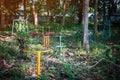 Old outdoor exercise equipment so worn out and covered in trees in outdoor exercise park. Old abandoned gym equipment on sports Royalty Free Stock Photo