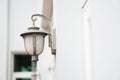 Old outdoor wall lamp light on white exterior Royalty Free Stock Photo