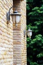 Old outdoor wall lamp light on brick wall tree background Royalty Free Stock Photo