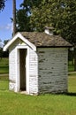 Old outhouse with birdhouse