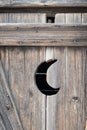 Old outhouse, crescent moon door Royalty Free Stock Photo