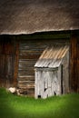 Old Outhouse with Rustic Looking Barn Royalty Free Stock Photo
