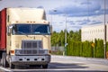 Old over engine cab big rig semi truck transporting container on the street road