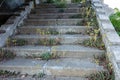 Old overgrown with destroyed stone balustrades old antique steps of a stone staircase. Ruined stairs. The dilapidated building, Royalty Free Stock Photo