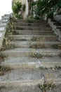 Old overgrown with destroyed stone balustrades old antique steps of a stone staircase. Ruined stairs. The dilapidated building, Royalty Free Stock Photo