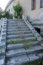Old overgrown with destroyed stone balustrades old antique steps of a stone staircase. Ruined stairs. The dilapidated building, Royalty Free Stock Photo