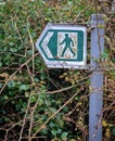 Old and overgrown public footpath sign
