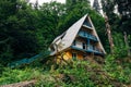 Old overgrown by trees ruined abandoned house in mountain forest Royalty Free Stock Photo