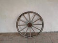 Old ox-wagon wheel leaned on a wall Royalty Free Stock Photo