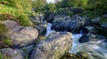 The old packhorse bridge known as Birk`s Bridge across the river Duddon near Seathwaite in the Lake District National Park Royalty Free Stock Photo