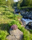 The old packhorse bridge known as Birk`s Bridge across the river Duddon near Seathwaite in the Lake District National Park Royalty Free Stock Photo