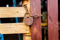 Old padlock attached to the wooden wall of shed with metal chain Royalty Free Stock Photo