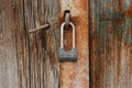 Old padlock on gates. A lock hangs on the wooden door Royalty Free Stock Photo
