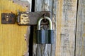 Old padlock hanging on a wooden shabby door Royalty Free Stock Photo