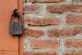 Old padlock on metal door. Red brick wall Royalty Free Stock Photo