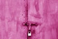 Old padlock on metal gate in pink tone. Royalty Free Stock Photo