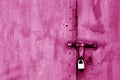 Old padlock on metal gate in pink tone. Royalty Free Stock Photo