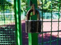 Old padlock on the net fence gate Royalty Free Stock Photo