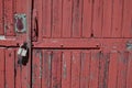 Old padlock on rustic red wooden door Royalty Free Stock Photo