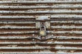 Old padlock on rusty iron door. Old rusty key lock steel door Royalty Free Stock Photo