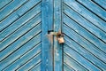 Old padlock on a weathered retro blue wooden door. Textured background. Royalty Free Stock Photo