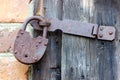 An old rusty padlock for closing ranch doors. Royalty Free Stock Photo