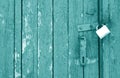 Old padlock on wooden gate in cyan tone Royalty Free Stock Photo