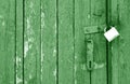 Old padlock on wooden gate in green tone Royalty Free Stock Photo