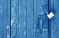 Old padlock on wooden gate in navy blue tone Royalty Free Stock Photo