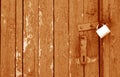 Old padlock on wooden gate in orange tone Royalty Free Stock Photo