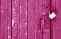 Old padlock on wooden gate in pink tone Royalty Free Stock Photo