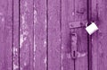 Old padlock on wooden gate in purple tone Royalty Free Stock Photo