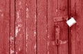 Old padlock on wooden gate in red tone Royalty Free Stock Photo