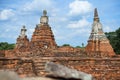 Old pagoda and ruined Buddha statue in Chaiwatthanaram temple.