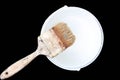 Old paint brush rest on top of paint tin isolated Royalty Free Stock Photo