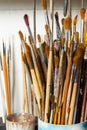Old paint brushes, a bunch in a jar. Close-up. Vertical frame