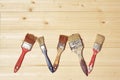 Old paint brushes on a wooden background.