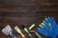 Old paint brushes and putty knife, blue building gloves. Royalty Free Stock Photo