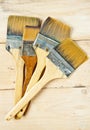 Old paint brushes on wooden background
