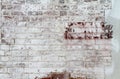 An old painted brick wall. White paint chipping and peeling.