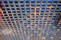 Old painted metal square mesh fencing in the playground. Royalty Free Stock Photo