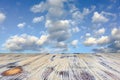 Old painted washed oak wooden table on the blue sky clouds background, wood table
