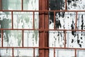 Old painted window behind rusty grate Royalty Free Stock Photo