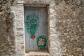 Old, painted wooden door of a ruined stone building from Roman times, Krk town, Croatia