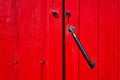 Old painted wooden red door with door handle Royalty Free Stock Photo