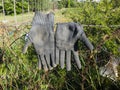 old pair of gardening gloves left hanging on a fence