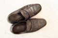 Old pair of Mens black dress shoes that are worn out, very dusty and dirty and falling apart.  They need polish and repair Royalty Free Stock Photo