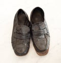 Old pair of Mens leather black dress shoes that are worn out, very dusty and dirty and falling apart.  They need polish and repair Royalty Free Stock Photo