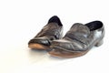 Old pair of Mens leather black dress shoes that are worn out, very dusty and dirty and falling apart.  They need polish and repair Royalty Free Stock Photo